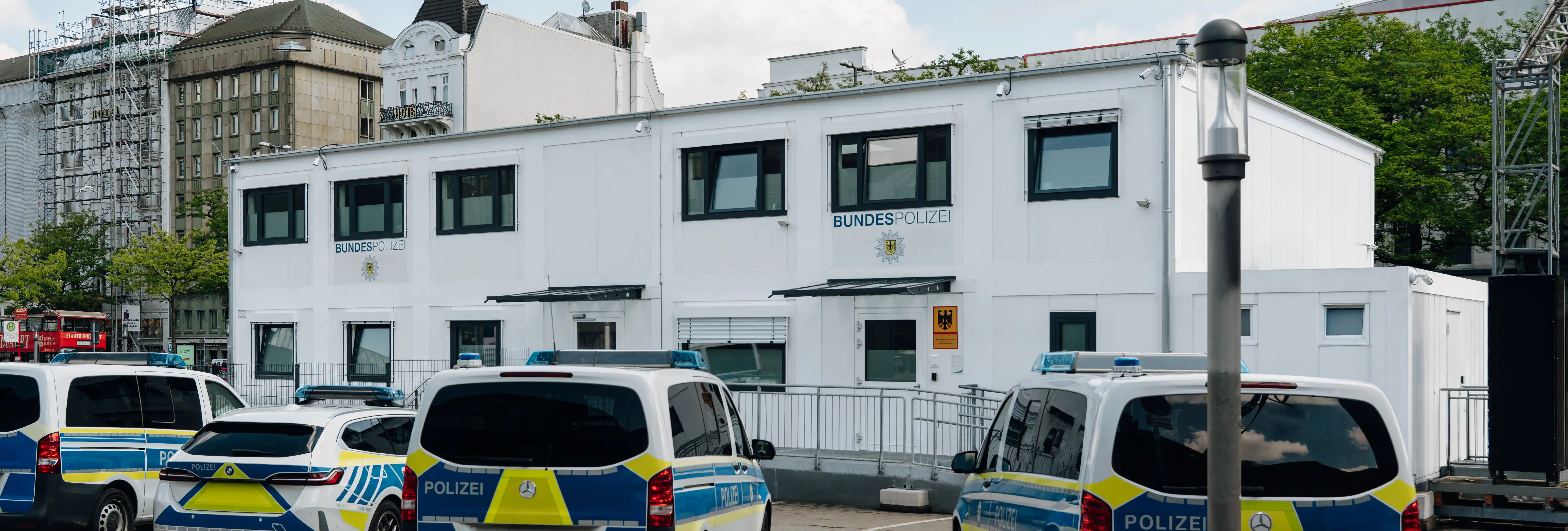 Bundespolizei-Dienstgebäude am Hamburger Hauptbahnhof mit mehreren Einsatzfahrzeugen auf dem Vorplatz.